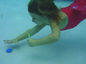 June, age 5, diving in about 5 feet of water.