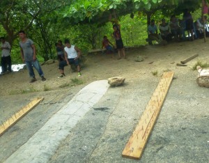 Zapatistas blocking our way with that tiny rope and boards full of nails. Notice the whole village is out watching. 